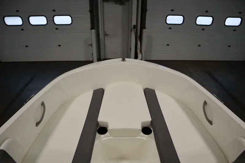 Slide: The Image of 2026 Bayliner Element E18 boat interior with seating, in a garage setting. - 10