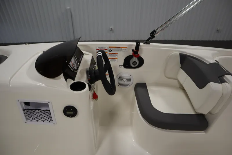 Slide: The Image of 2026 Bayliner Element E18 boat interior with steering wheel and seating. - 14