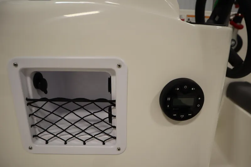 Slide: The Image of 2026 Bayliner Element E18 boat dashboard with storage compartment and control panel. - 15