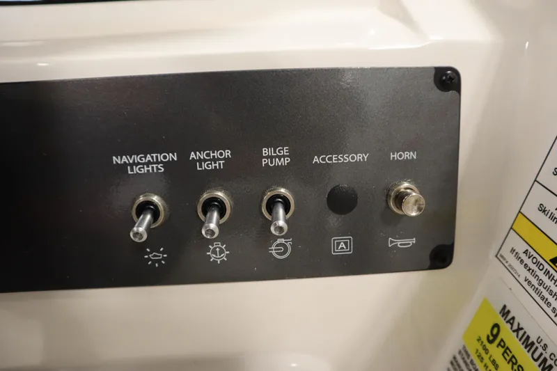 Slide: The Image of Control panel of 2026 Bayliner Element E18 with switches for navigation lights, anchor light, bilge pump, accessory, and horn. - 18