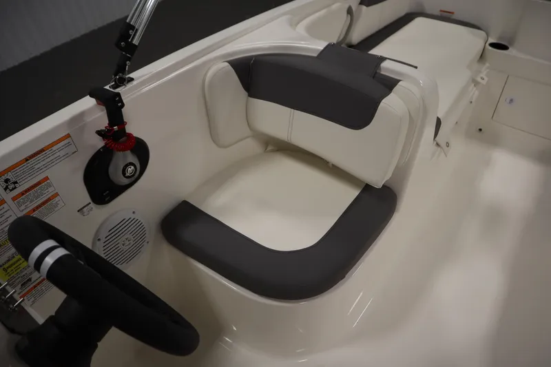 Slide: The Image of 2026 Bayliner Element E18 boat interior with steering wheel and cushioned seating. - 20