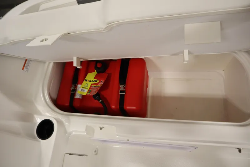 Slide: The Image of Storage compartment of 2026 Bayliner Element E18 with red fuel tank. - 25