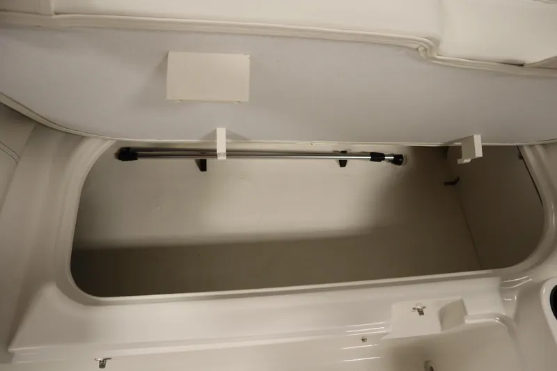 Slide: The Image of 2026 Bayliner Element E18 storage compartment, open and empty, showcasing interior space. - 26