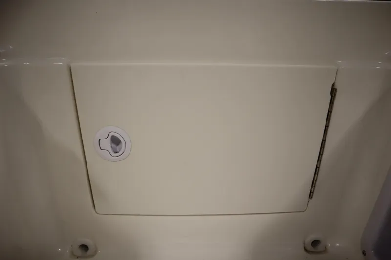 Slide: The Image of 2026 Bayliner Element E18 storage compartment with latch and hinge detail. - 27