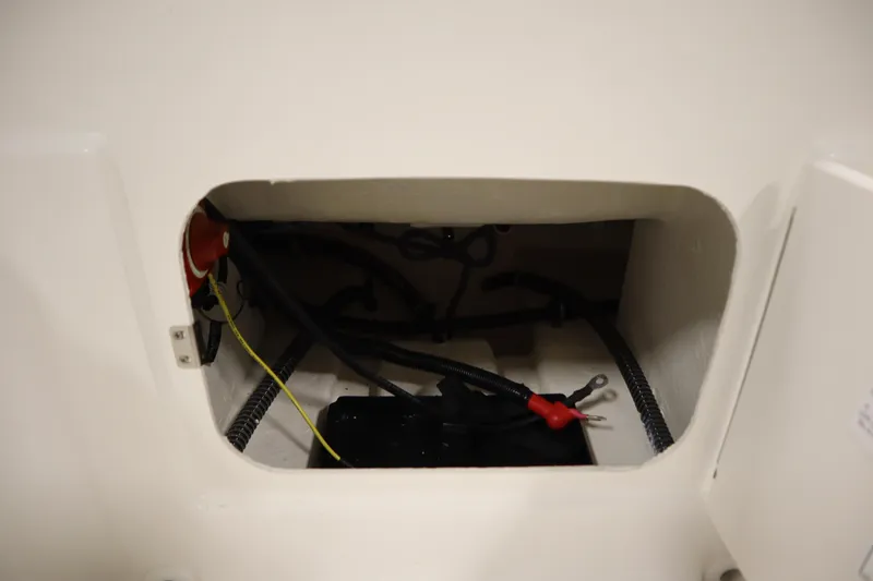 Slide: The Image of 2026 Bayliner Element E18 boat compartment with wiring and battery connections. - 28