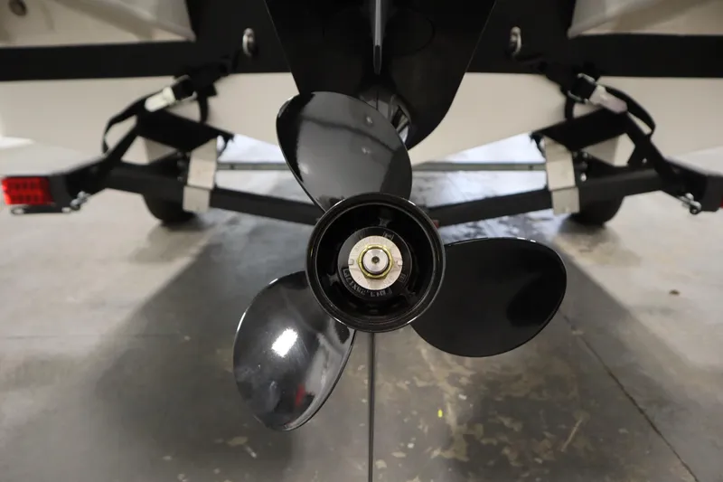 Slide: The Image of 2026 Bayliner Element E18 boat propeller and trailer close-up in a garage. - 32
