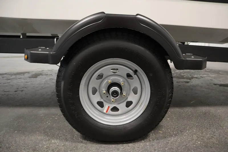 Slide: The Image of Trailer wheel of 2026 Bayliner Element E18 boat, close-up view. - 35