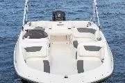 Slide: The Image of 2026 Bayliner Element E18 boat with Mercury outboard motor in a garage setting. - 4