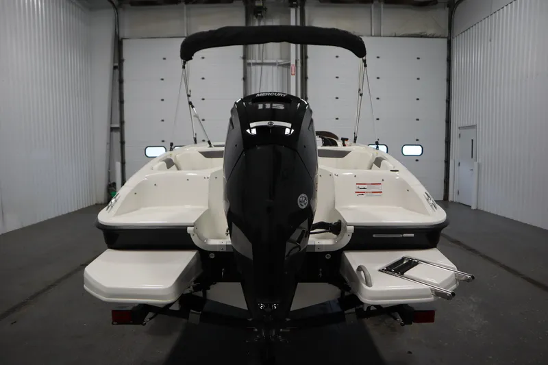 Slide: The Image of 2026 Bayliner Element E18 boat in a garage, rear view with outboard motor. - 5