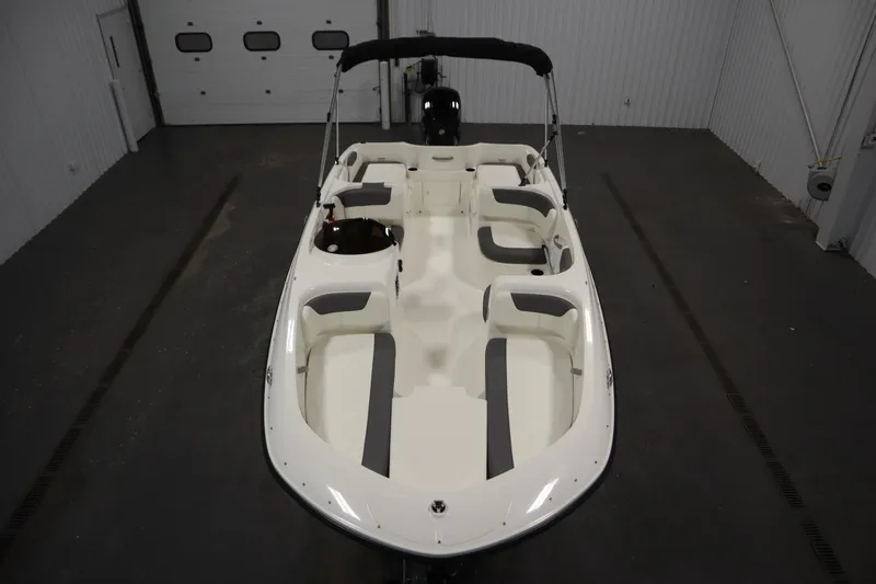 Slide: The Image of 2026 Bayliner Element E18 boat in a spacious indoor storage facility. - 8