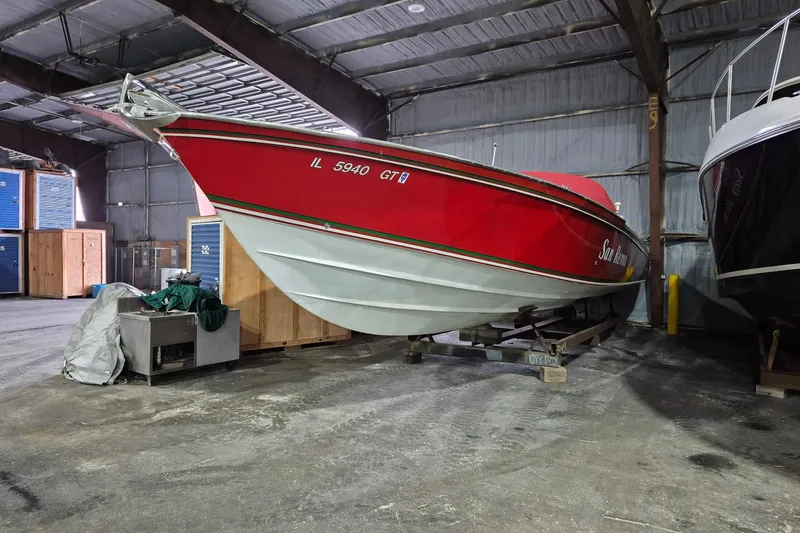 Slide: The Image of Red 1982 Magnum 40 boat stored indoors, showcasing sleek design and vibrant color. - 10