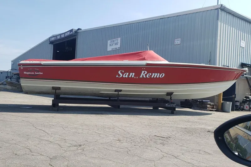 Slide: The Image of Red 1982 Magnum 40 boat named "San Remo" on display at a yacht yard. - 11