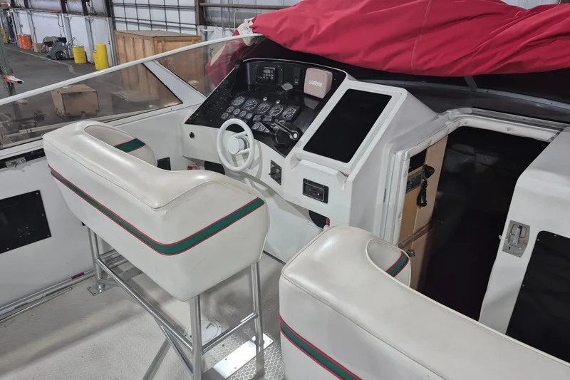 Slide: The Image of Interior of a 1982 Magnum 40 boat with white seating and control panel. - 12