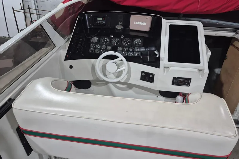 Slide: The Image of Cockpit of a 1982 Magnum 40 boat with steering wheel and control panel. - 13