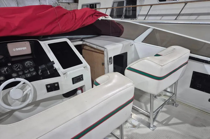 Slide: The Image of Interior of a 1982 Magnum 40 boat with white seats and navigation controls. - 14