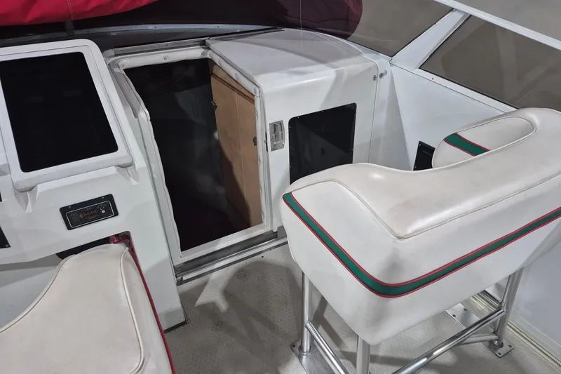Slide: The Image of Interior of a 1982 Magnum 40 boat with white seating and cabin entrance. - 15