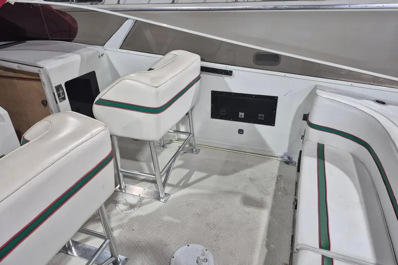 Slide: The Image of 1982 Magnum 40 boat interior with white seating and green-red accents. - 16