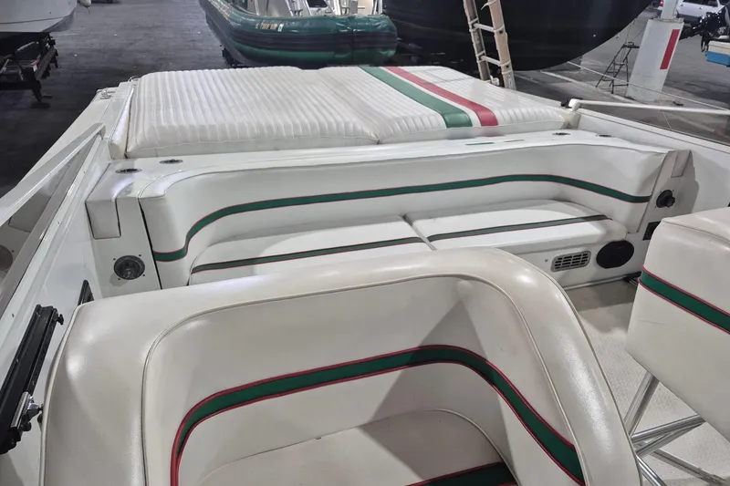 Slide: The Image of Interior of a 1982 Magnum 40 boat with white and striped seating. - 18