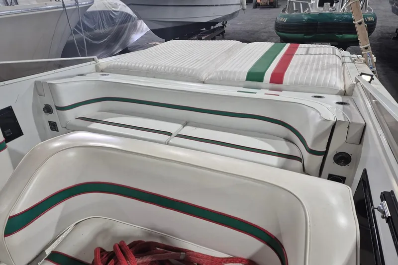Slide: The Image of 1982 Magnum 40 boat interior with white seating, green and red accents. - 19