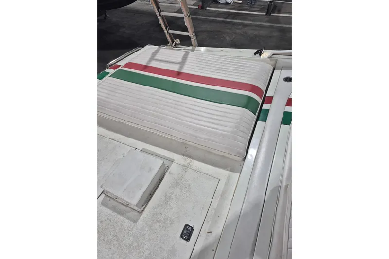 Slide: The Image of 1982 Magnum 40 boat deck with striped upholstery in red, green, and white. - 21