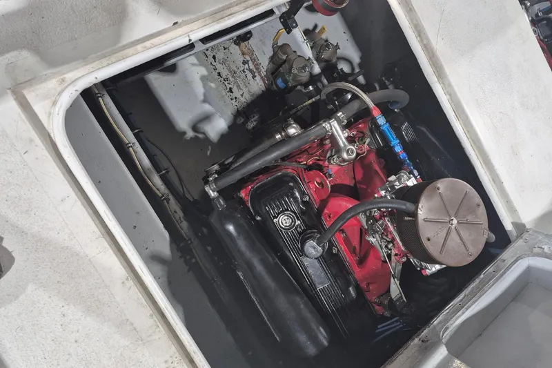 Slide: The Image of Engine compartment of a 1982 Magnum 40 boat, showcasing a red and black engine. - 23