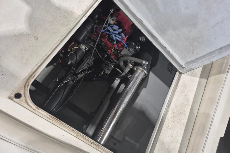 Slide: The Image of Engine compartment of a 1982 Magnum 40 boat, showcasing mechanical components and wiring. - 25