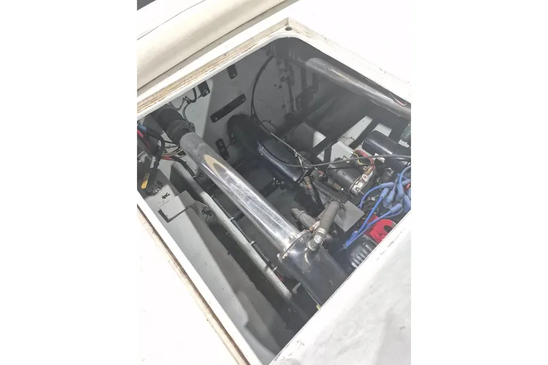 Slide: The Image of Engine compartment of a 1982 Magnum 40 boat, showcasing mechanical components and wiring. - 26