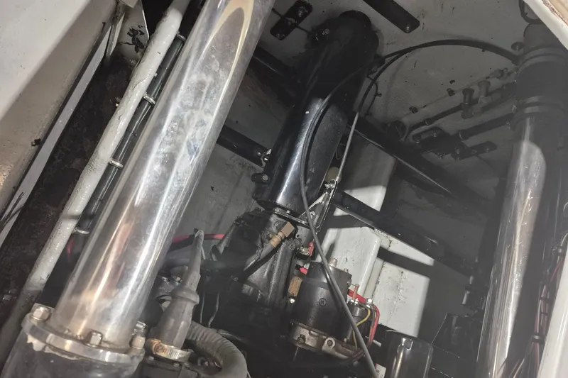 Slide: The Image of Engine compartment of a 1982 Magnum 40, showcasing mechanical components and wiring. - 27