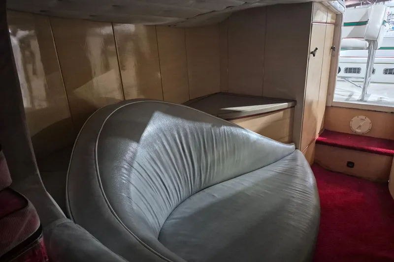 Slide: The Image of Interior of a 1982 Magnum 40 boat with curved seating and red carpet. - 33