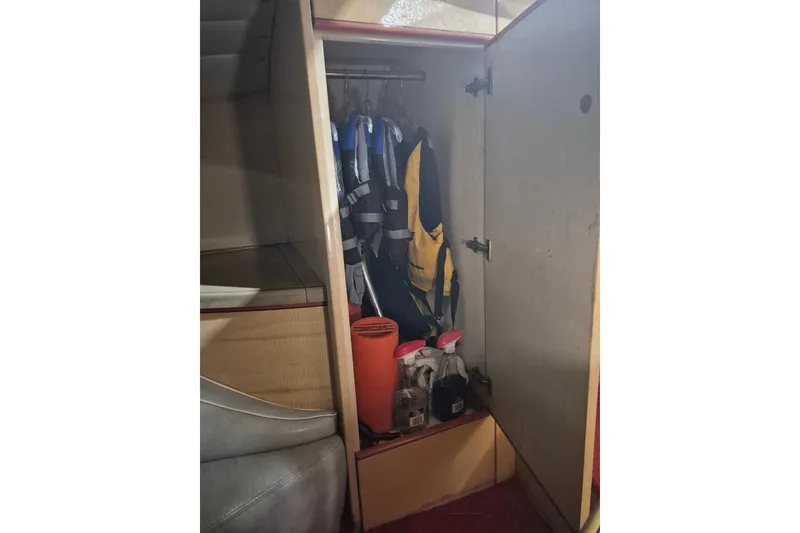 Slide: The Image of Interior storage of 1982 Magnum 40 boat with life jackets and cleaning supplies. - 34