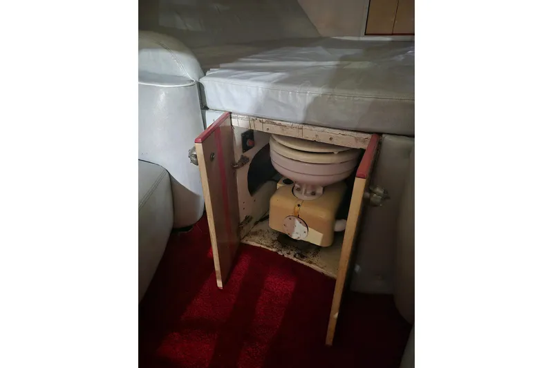 Slide: The Image of 1982 Magnum 40 interior with open cabinet revealing a hidden toilet. - 36