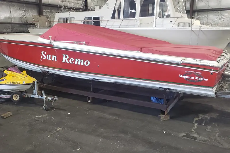 Slide: The Image of Red 1982 Magnum 40 boat named "San Remo" in storage, covered with a red tarp. - 4