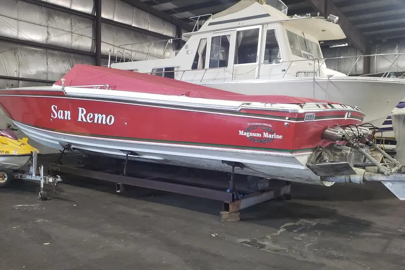 Slide: The Image of Red 1982 Magnum 40 boat named "San Remo" in a storage facility. - 5