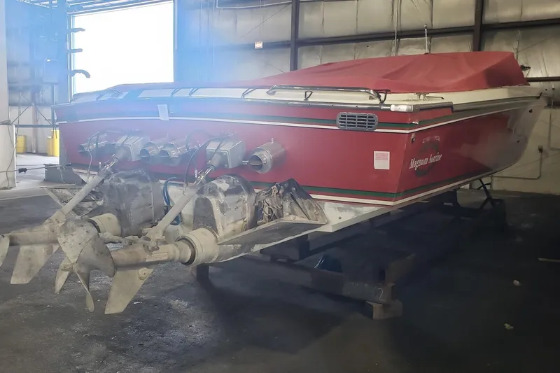 Slide: The Image of Red 1982 Magnum 40 boat with dual propellers in a warehouse setting. - 8