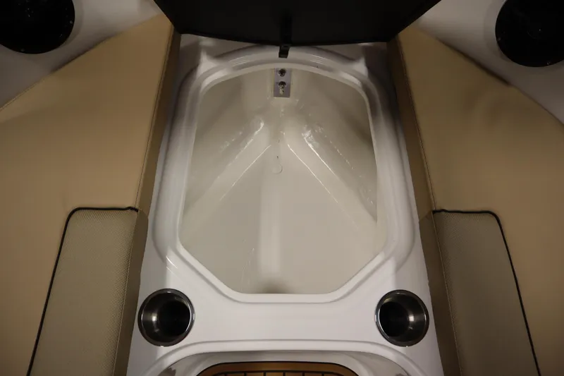 Slide: The Image of 2025 Bayliner VR6 Bowrider OB interior with beige seating and cup holders. - 11