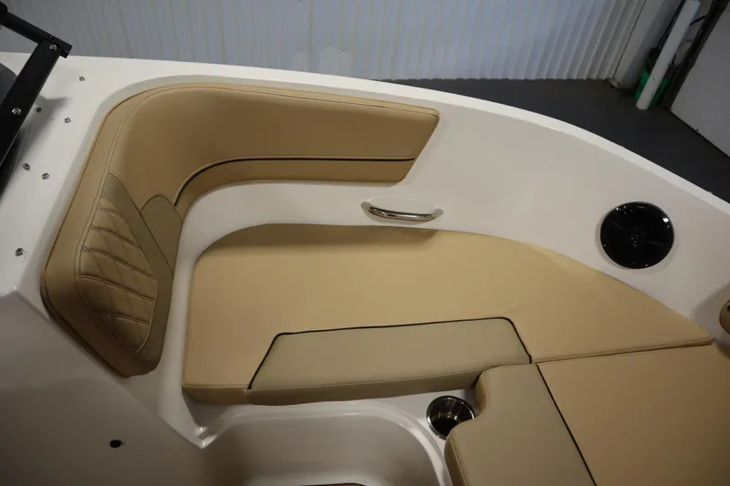 Slide: The Image of 2025 Bayliner VR6 Bowrider OB interior with tan seating and speaker. - 12