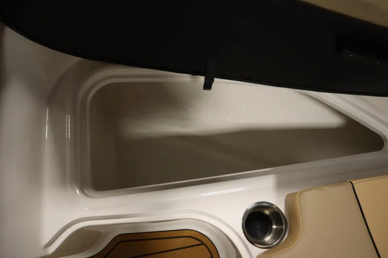 Slide: The Image of 2025 Bayliner VR6 Bowrider OB storage compartment with cup holder and seating detail. - 13