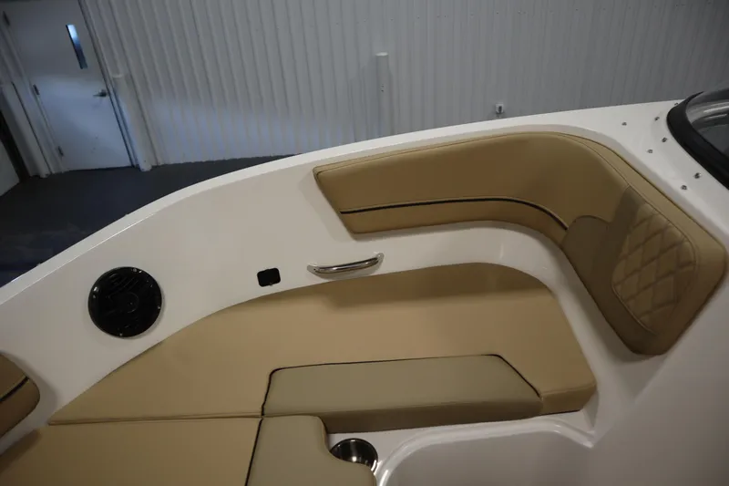 Slide: The Image of 2025 Bayliner VR6 Bowrider OB interior with tan seating and speaker detail. - 14