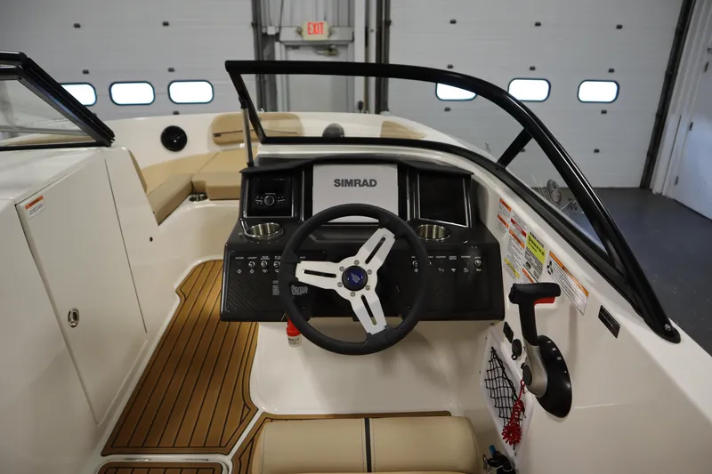 Slide: The Image of 2025 Bayliner VR6 Bowrider OB cockpit with steering wheel and control panel. - 17