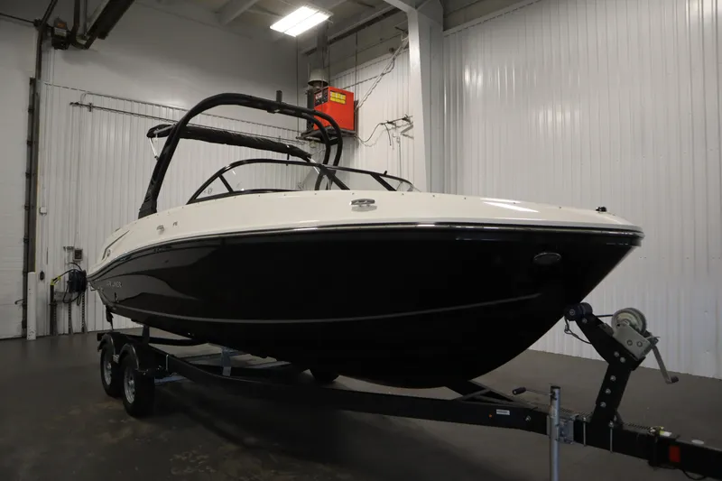 Slide: The Image of 2025 Bayliner VR6 Bowrider OB in a showroom, showcasing sleek design and modern features. - 2
