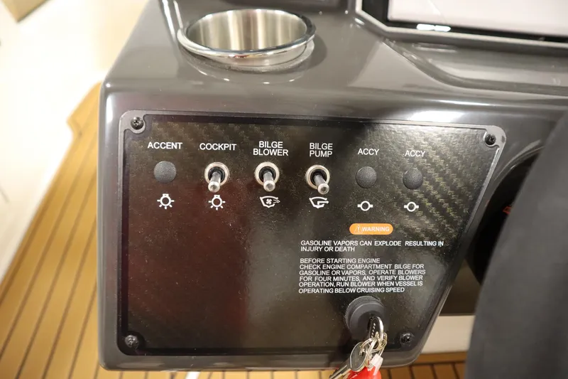 Slide: The Image of 2025 Bayliner VR6 Bowrider OB control panel with switches and safety warning. - 22