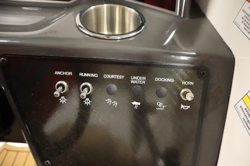 Slide: The Image of Control panel of 2025 Bayliner VR6 Bowrider OB with switches for anchor, lights, and horn. - 23