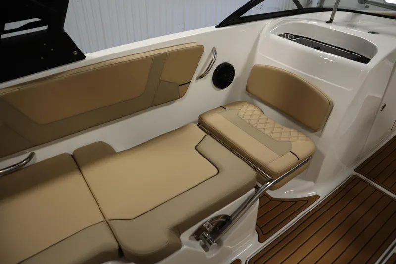 Slide: The Image of 2025 Bayliner VR6 Bowrider OB interior with tan seating and wood-style flooring. - 38