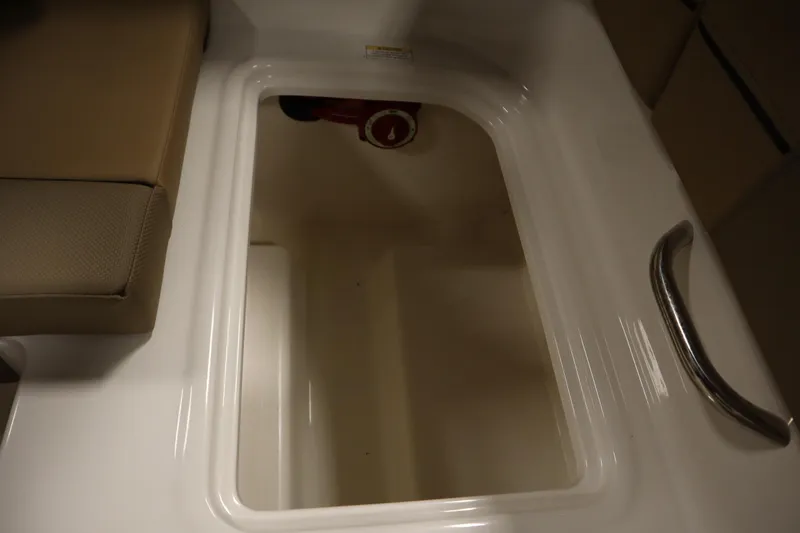 Slide: The Image of 2025 Bayliner VR6 Bowrider OB storage compartment with cushioned seating and handle. - 41