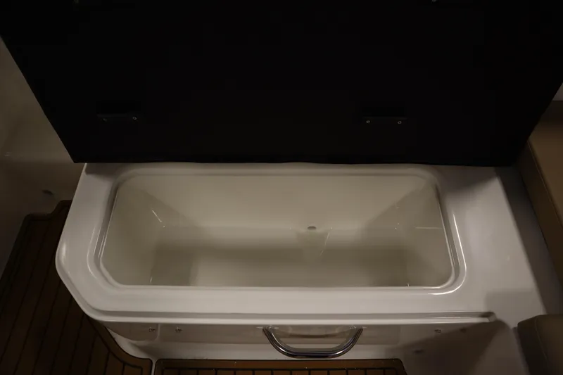 Slide: The Image of 2025 Bayliner VR6 Bowrider OB storage compartment, open lid, interior view. - 44