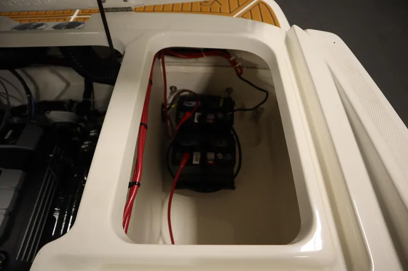 Slide: The Image of 2025 Bayliner VR6 Bowrider OB battery compartment with wiring and engine components. - 47