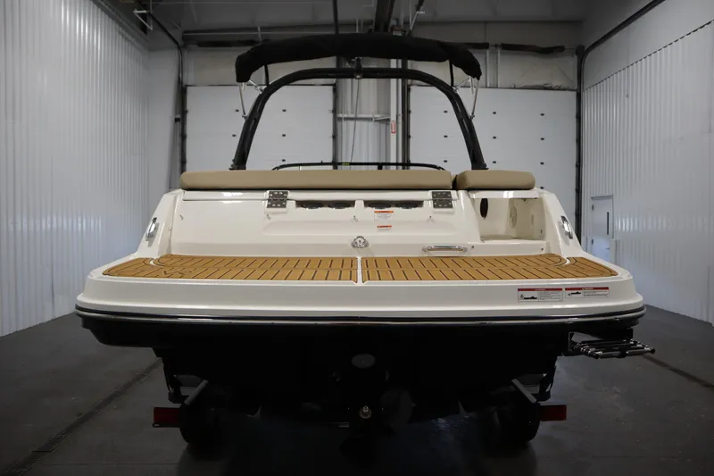 Slide: The Image of 2025 Bayliner VR6 Bowrider OB, rear view in a garage setting. - 5