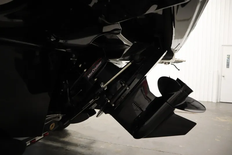 Slide: The Image of 2025 Bayliner VR6 Bowrider OB with MerCruiser engine detail in a showroom. - 52