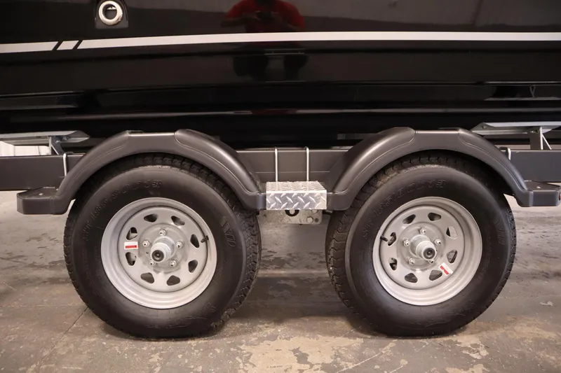 Slide: The Image of Trailer wheels of 2025 Bayliner VR6 Bowrider OB boat, featuring sturdy tires and fenders. - 57