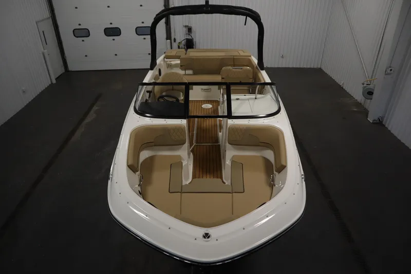 Slide: The Image of 2025 Bayliner VR6 Bowrider OB in a garage, showcasing spacious seating and sleek design. - 8